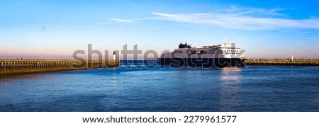 Lighthouse, pier and ferryboat in Calais beach, France