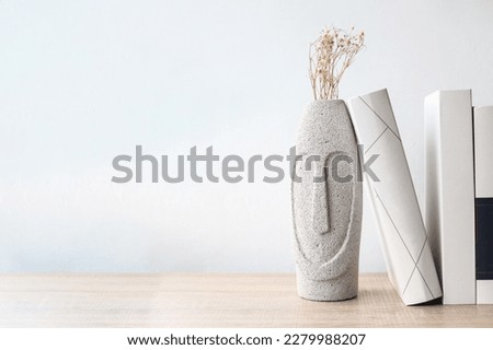Minimalist background, books, dried flowers and pots on a white background.