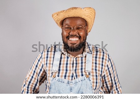 brazilian black man wearing country clothes from festa junina, festa de são joão. close-up smiling.