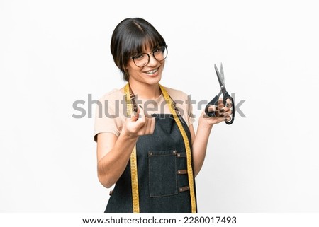 Young caucasian seamstress over isolated white background making money gesture