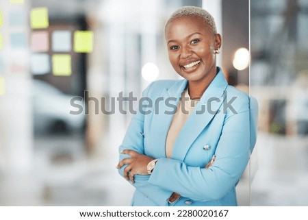Black woman, portrait smile and arms crossed in small business management leaning proud on glass at office. Happy African American female smiling in confidence for corporate planning at workplace