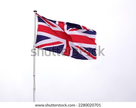 British flag flying at full mast in wind Royalty-Free Stock Photo #2280020701