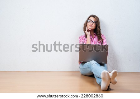 Young creative woman sitting in the floor with laptop./ Casual blogger woman Royalty-Free Stock Photo #228002860