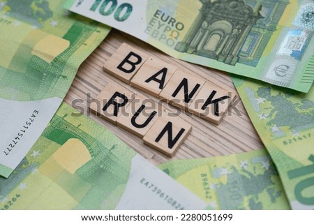 inscription bank run next to euro banknotes. Flat lay photo showing US and European banking crisis Royalty-Free Stock Photo #2280051699