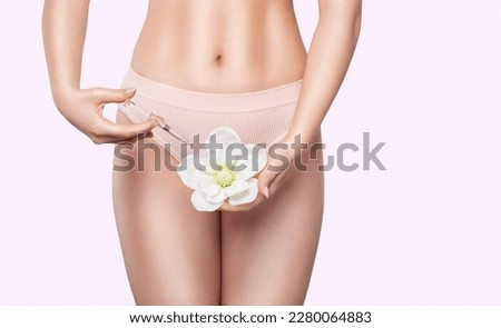 A woman holds a flower in her hands and makes injections for rejuvenation. The concept of plastic surgery. Royalty-Free Stock Photo #2280064883