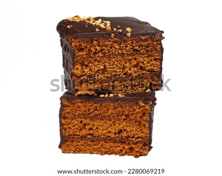 A ginger bread cake slice with plum jam filling cut in half stacked studio shot isolated on white background