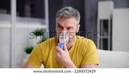 Asthma Patient Breathing Using Oxygen Mask And COPD Nebulizer Royalty-Free Stock Photo #2280072429