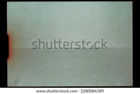 scan of blank or empty super 8mm film frame with dust and scratches, cool film border overlay. super 8 template or mockup. Royalty-Free Stock Photo #2280086589