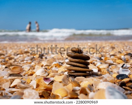 Sea stones balance and wellness on the beach on a sunny day. Zen meditation, relaxation, harmony and balance. The concept of Zen.