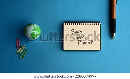 There is a notebook with the word Save our Planet. It is eye-catching image.