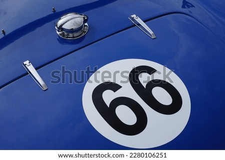 Race number 66 on vintage blue racing car