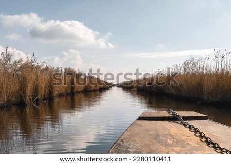 Beautiful scenery on the river and fishing boat, wetland national park Delta Evros Greece. Royalty-Free Stock Photo #2280110411