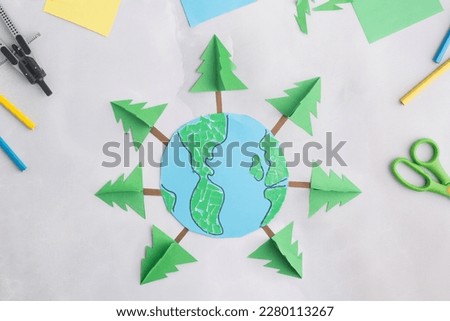 earth cut from paper around trees earth day concept kid's paper craft