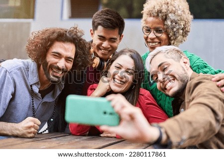 Happy multiracial friends having fun taking selfie - Young happy people together using smartphone. High quality photo