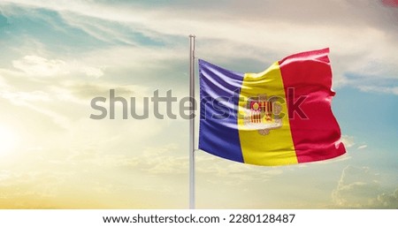 Andorra national flag waving in beautiful sky.