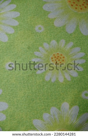 A green cloth with a white or jasmine floral pattern can be used as a background