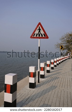 Walking Sign on a new road side by a river in kerala, India