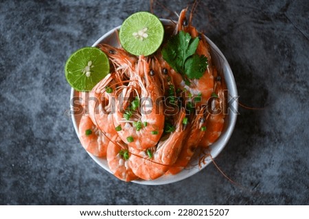 shrimp on white bolw and wooden background dining table food, Fresh shrimps prawns seafood lemon lime with herbs and spice, top view