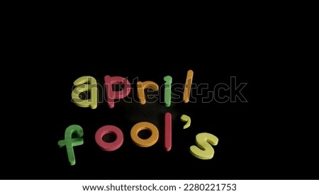 April Fools words in various color and note book isolated in black background 