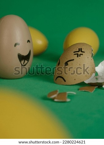 Yellow eggs and brown eggs with facial expressions isolated in green background, easter eggs