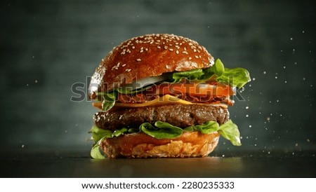 Delicious fresh cheeseburger with old grey background. Fresh american kitchen. Royalty-Free Stock Photo #2280235333