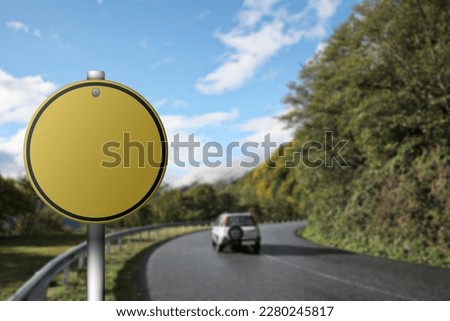 Blank yellow road sign on asphalt highway, space for text