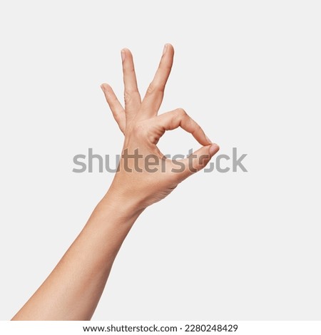 woman's hand making ok sign isolated	 Royalty-Free Stock Photo #2280248429