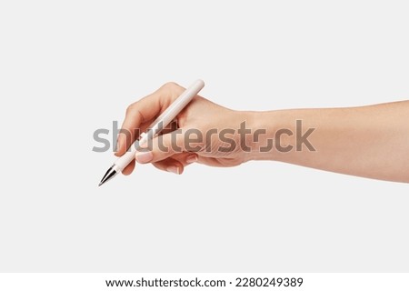 a woman's hand holding a pen Royalty-Free Stock Photo #2280249389