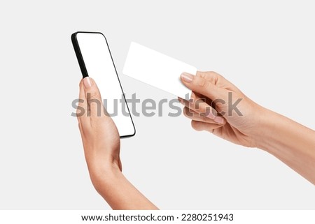 Woman Paying with a credit card in a terminal that is a mobile phone, NFC wireless payments, Contactless