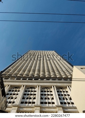 A low angle view of State Tower against clear blue sky.