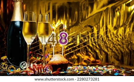 Copy space solemn background. Happy birthday golden background with number  48. Greeting card or postcard with a bottle of champagne with poured champagne in glasses.