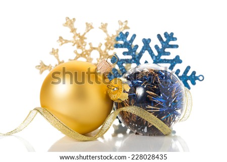 Golden and blue christmas ornaments on white background with space for text