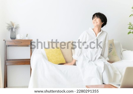 Asian (Japanese) woman relaxing in her room Morning image