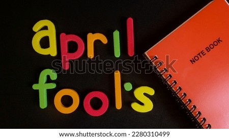 Words April fools isolated in black background , first of April 
