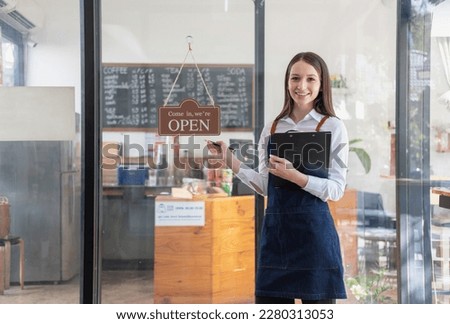Portrait of a woman, a coffee shop business owner smiling beautifully and opening a coffee shop that is her own business, Small business concept.	