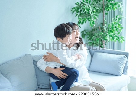 jubilant young mother and son Royalty-Free Stock Photo #2280315361