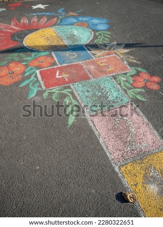 colored hopscotch game on asphalt