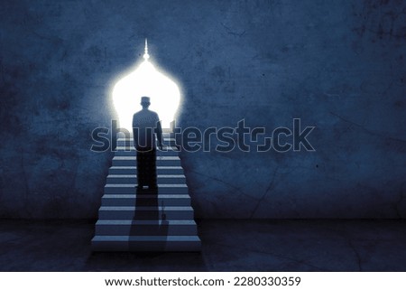 Rear view of young Muslim man holding prayer beads climbing stairs towards holly door