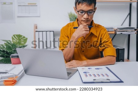 Young Serious asia people bookkeeper doing bookkeeping entrepreneur small business owner accountant in office with balance sheet, income tax return and budget of local business.