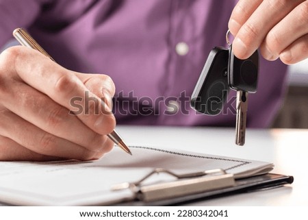 Business concept, car insurance, sell and buy car, car financing, car key for Vehicle Sales Agreement. New carowners are taking keys from male salespeople. Royalty-Free Stock Photo #2280342041