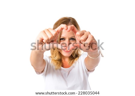 Girl making a heart with her hands over white background