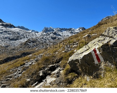 Hiking trails or mountaineering routes in the autumn Swiss Alpine environment of the Albula Alps and above the mountain road pass Fluela (Flüelapass), Zernez - Canton of Grisons, Switzerland (Schweiz)