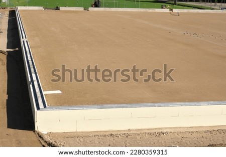 prepared base and concrete border for installation of inflatable playing arena, football hall, air dome Royalty-Free Stock Photo #2280359315