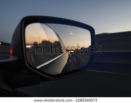 the eid moon looks on car looking glass Royalty-Free Stock Photo #2280360073