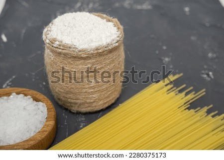 Pasta, flour, sugar, salt on a dark background.
macro photography. Bakery products.