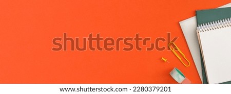 School stationery on red background. Top view with copy space. Flat lay. Back to school concept.
