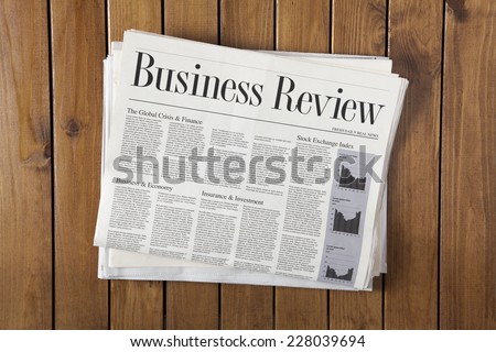 Daily newspaper stack on the wooden table Royalty-Free Stock Photo #228039694
