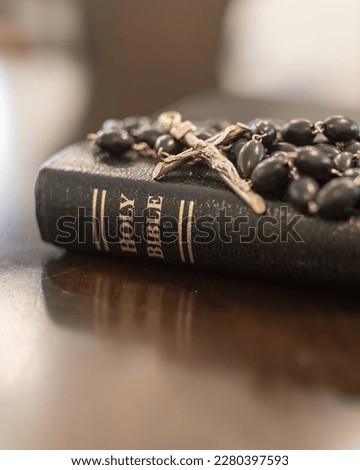 Catholic rosary and crucifix laying on leather bound holy Bible close up, Christian, Christianity, faith and grace of Jesus Christ