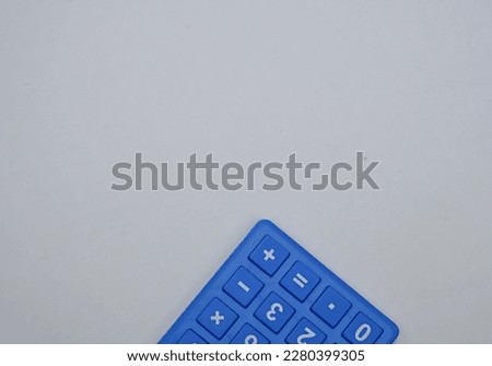 A calculator is a small electronic device used for mathematical calculations. It has a numerical keypad and a digital display. This particular calculator is pictured on a white background.