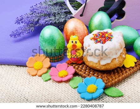 Easter composition. Easter cake, painted Easter eggs and lavender branches on a background of burlap.